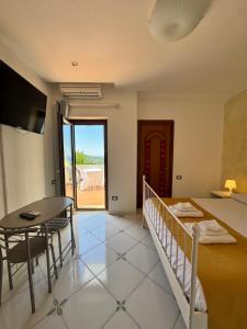 a room with a bed and a table and a dining room at Villa Setharè in Salerno