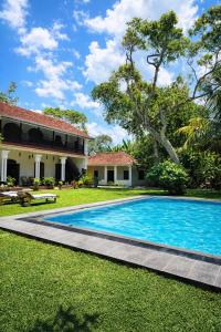 an image of a swimming pool in front of a house at Agwe Villa - Hikkaduwa in Dodanduwa