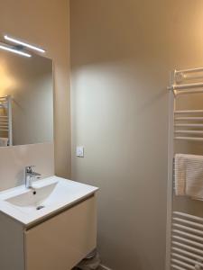 a bathroom with a white sink and a mirror at Lamayade in Arcachon +27 photos
