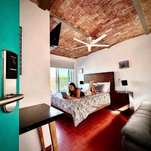a woman laying on a bed in a bedroom at Hostal Nube Mia Guadalajara in Guadalajara