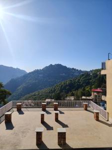 a large patio with benches on top of a building at Saadhan Homestay in Mussoorie