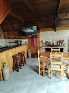 a kitchen with a table and chairs and a stove at Reserva Natural Cerro Alto in Empalme +66 photos