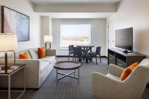 a living room with a couch and a table at Courtyard by Marriott across Universal Orlando in Orlando