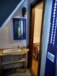 a bathroom with a sink and a mirror at Maramureș Traditional House in Vadu Izei +47 photos