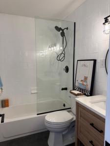 a bathroom with a shower and a toilet and a sink at Azur East, Southampton in Southampton
