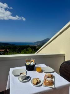a table with two plates of food and drinks on it at Villa Setharè in Salerno
