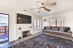 a living room with a couch and a fireplace at Hot Tub, Pool, Dock: 2 Cabins Lakeview Grand Lake in Grove