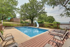 a swimming pool on a deck with two chairs and a slide at Hot Tub, Pool, Dock: 2 Cabins Lakeview Grand Lake in Grove