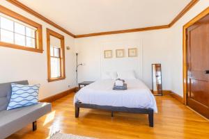 a bedroom with a bed and a couch at 152 Quite & Bright & Spacious Apt in Brighton in Boston