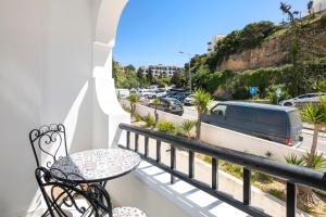 a balcony with a table and a view of a street at CASA LEONE - fully renovated since April 2026 - new pictures in Carvoeiro