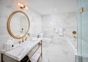 a bathroom with a sink and a mirror and a toilet at Pantages Hotel Toronto Centre in Toronto +35 photos