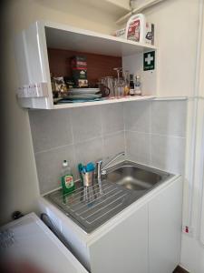 a small kitchen with a sink and a counter at Elias Apartment in Kissonerga +19 photos