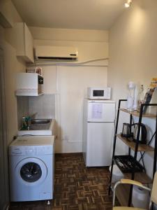 a small kitchen with a washing machine and a washer at Elias Apartment in Kissonerga
