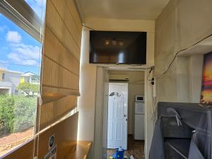 a wall with a flat screen tv on top of a house at Elias Apartment in Kissonerga