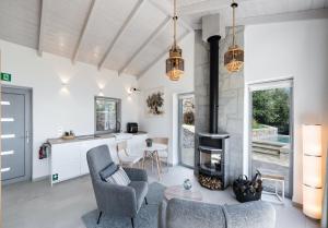 an open living room with a fireplace and a kitchen at Grey Sea View Estate - Luxury Villas with Private Pool & Plunge Pool in Katouna