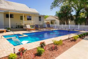 a swimming pool in the backyard of a house at Drackett House by Whiskey Properties in Bay Saint Louis