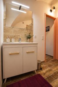 a bathroom with a sink and a mirror at L'écrin du Pont du Gard - Parking gratuit - Charme & Pierres in Remoulins