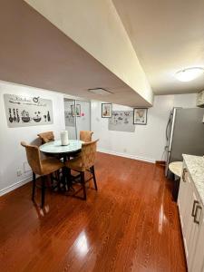 a kitchen and dining room with a table and chairs at Spacious room near subway & shops in Toronto