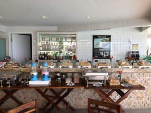 a kitchen with a counter with food on it at KING's FLAT HOTEL NATAL in Natal