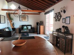 a living room with a couch and a table at Casinhas in Praia do Almoxarife
