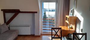 a living room with a couch and a table and a window at Spichlerz in Rydzewo