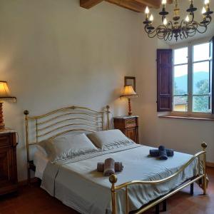 a bedroom with a bed with two hats on it at Charming LUCCA in Lucca