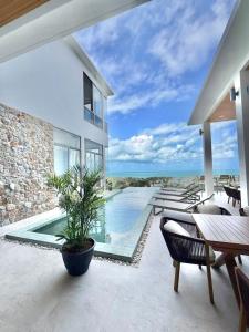 a villa with a swimming pool and a patio at Villa luxurious in Koh Samui