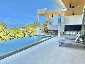 an open living room with a pool and a tv at Villa luxurious in Koh Samui