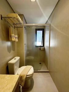 a small bathroom with a toilet and a shower at Flat Executive City Jardins in São Paulo +29 photos
