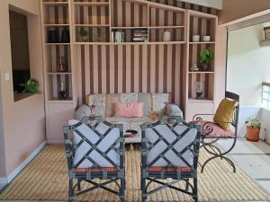 a living room with a couch and a table and chairs at CosyNest Apartment in Cap Malheureux