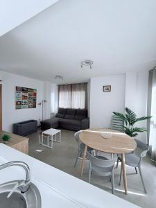 a living room with a table and a couch at Iberflat Apartamentos Marina Suites in Grao de Castellón