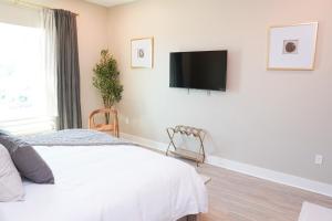 a bedroom with a bed and a flat screen tv on the wall at Hotel Whiskey in Long Beach in Long Beach +29 photos