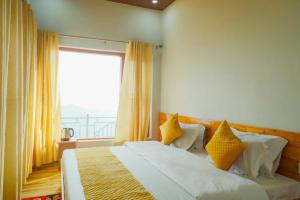 a bedroom with a bed with yellow pillows and a window at Baatuli Homestay in Nainital +6 photos