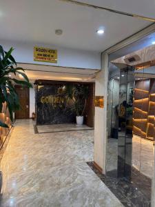 a lobby of a hotel with a sign on the wall at Golden Hotel in Hanoi