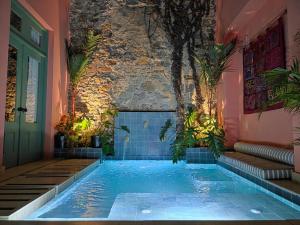 a swimming pool in the middle of a house at Casa AcoModo at Casco Viejo 6BR Mansion w Pool in Panama City +66 photos