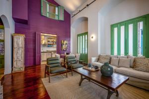 a living room with purple and green walls at Casa AcoModo at Casco Viejo 6BR Mansion w Pool in Panama City