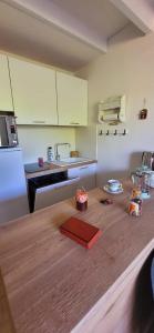 a kitchen with a wooden table with a counter top at Duplex Camargue Village in Le Grau-du-Roi