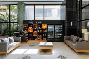 a room with two couches and a shelf of wine bottles at Flat Executive City Jardins in São Paulo
