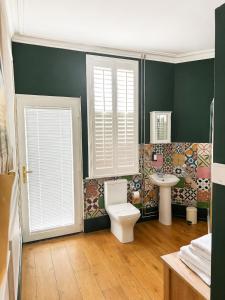 a bathroom with a toilet and a sink at The Olive in Market Rasen