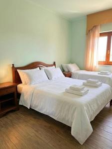 a bedroom with two beds with towels on them at Agriturismo Montebeltrano in Paterno Calabro