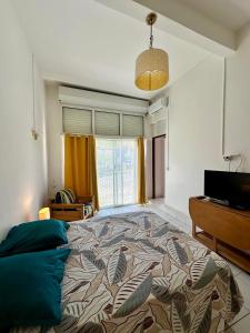 a bedroom with a large bed and a television at Studio Café & Studio Cacao in Îlet à Christophe