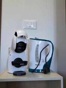 a white and blue coffee maker on a shelf at Masseria La Rocca in Pacentro
