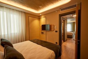 a hotel room with a bed and a television at igman Hotel İstanbul in Istanbul