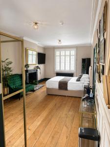 a large bedroom with a bed and a fireplace at The Olive in Market Rasen
