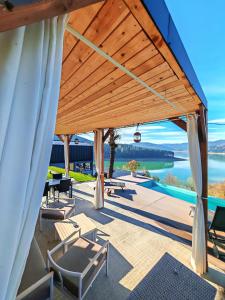 a pavilion with a view of the water at Moon Lake Bicaz - Casa Oia in Buhalniţa