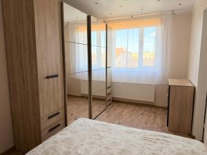a bedroom with a bed and a window at Kesk Central Apartment in Valga +9 photos