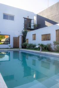 a swimming pool in front of a house at Las Golondrinas Mar del Plata in Mar del Plata