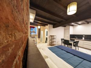 a kitchen and a living room with a bed in a room at Le torri Virgo in Fossano