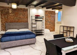 a bedroom with a bed and a table and chairs at Le torri Virgo in Fossano