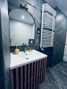 a bathroom with a sink and a mirror at ApartamentyM&K in Balice +14 photos